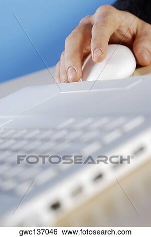 Stock Photograph - Close-up of a person's hand using a computer mouse. Fotosearch