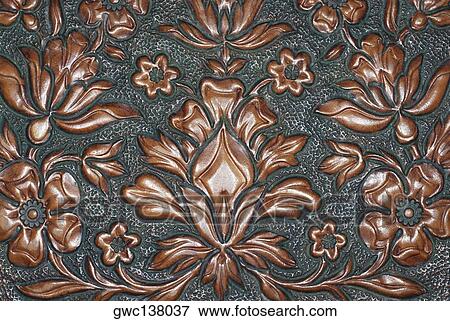Stock Photo - Close-up of a floral pattern carved on a wooden surface. Fotosearch