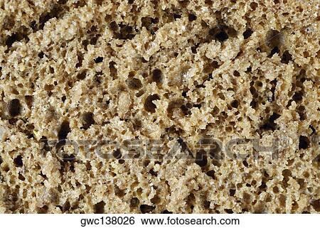 Close-up of a slice of brown bread View Large Photo Image Stock Photograph - Close-up of a slice of brown bread. Fotosearch