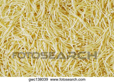 Close-up of uncooked macaroni View Large Photo Image Stock Photo - Close-up of uncooked macaroni. Fotosearch