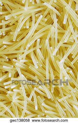 Close-up of uncooked macaroni View Large Photo Image Stock Photo - Close-up of uncooked macaroni. Fotosearch