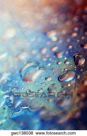 Stock Photo - Close-up of water drops on a blue surface. Fotosearch