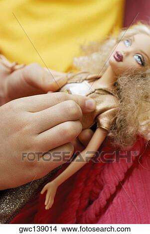 Close-up of a child's hand holding a doll View Large Photo Image Picture - Close-up of a child's hand holding a doll. Fotosearch