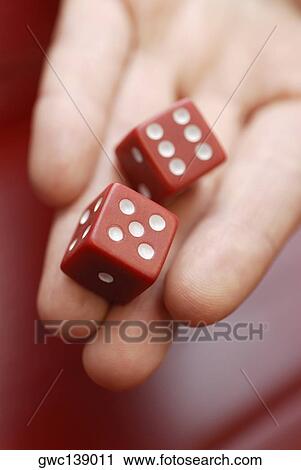 Close-up of a human hand holding two dice View Large Photo Image Stock Image - Close-up of a human hand holding two dice. Fotosearch