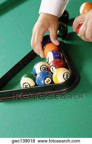 Close-up of a person's hand arranging pool balls View Large Photo Image Stock Photo - Close-up of a person's hand arranging pool balls. Fotosearch
