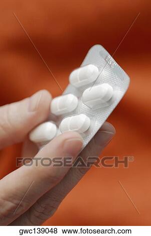 Close-up of a person's hand holding a blister pack View Large Photo Image Stock Photo - Close-up of a person's hand holding a blister pack. Fotosearch