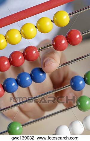Close-up of a person's hand using an abacus View Large Photo Image Stock Image - Close-up of a person's hand using an abacus. Fotosearch
