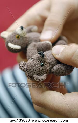 Close-up of a person's hands holding teddy bears View Large Photo Image Stock Image - Close-up of a person's hands holding teddy bears. Fotosearch