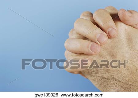Stock Photograph - Close-up of person's hands clasped. Fotosearch