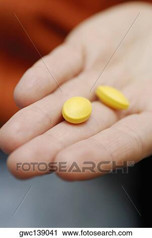 Close-up of two pills on a person's hand View Large Photo Image Stock Image - Close-up of two pills on a person's hand. Fotosearch