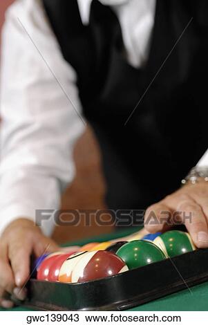 Mid section view of a man racking up pool balls on a pool table View Large Photo Image Stock Image - Mid section view of a man racking up pool balls on a pool table. Fotosearch