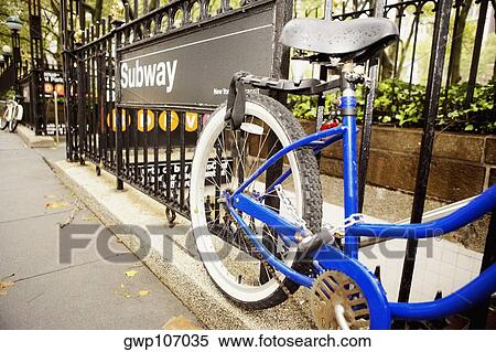 Close-up of a bicycle locked to a subway station railing View Large Photo Image Stock Photography - Close-up of a bicycle locked to a subway station railing. Fotosearch