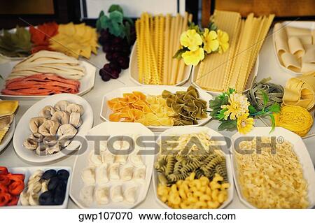Close-up of uncooked assorted pastas and dumplings in trays View Large Photo Image Stock Image - Close-up of uncooked assorted pastas and dumplings in trays. Fotosearch