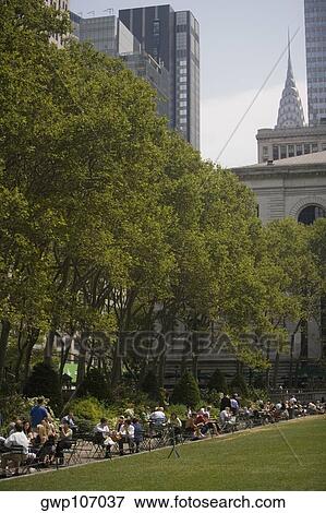 Group of people in a park with skyscrapers in the background, Chrysler Building, Manhattan, New York City, New York State, USA View Large Photo Image Stock Photo - Group of people in a park with skyscrapers in the background, Chrysler Building, Manhattan, New York City, New York State, USA. Fotosearch