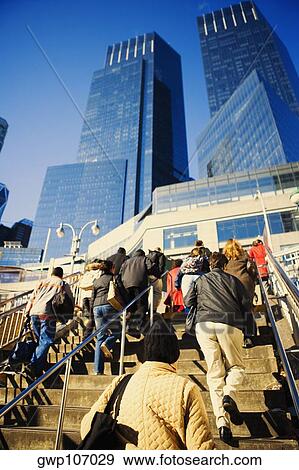 Low angle view of a large group of people walking up stairs View Large Photo Image Stock Photo - Low angle view of a large group of people walking up stairs. Fotosearch