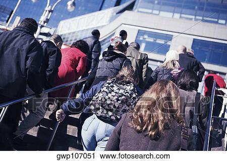 Low angle view of men and women walking up stairs View Large Photo Image Stock Image - Low angle view of men and women walking up stairs. Fotosearch