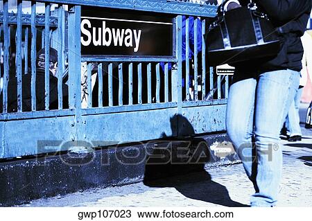Low section view of a man passing in front of a subway sign View Large Photo Image Stock Image - Low section view of a man passing in front of a subway sign. Fotosearch