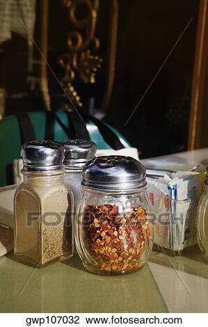 Stock Image - Pepper shaker and salt shaker on the floor. Fotosearch