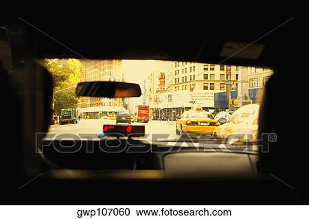 Stock Image - Rear view of a person in a car. Fotosearch