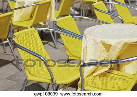 Chairs and tables at a sidewalk cafe, Venice, Veneto, Italy View Large Photo Image Stock Photo - Chairs and tables at a sidewalk cafe, Venice, Veneto, Italy. Fotosearch