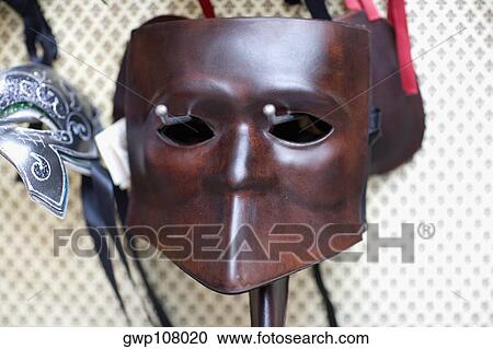Close-up of a mask hanging on a wall View Large Photo Image Stock Image - Close-up of a mask hanging on a wall. Fotosearch