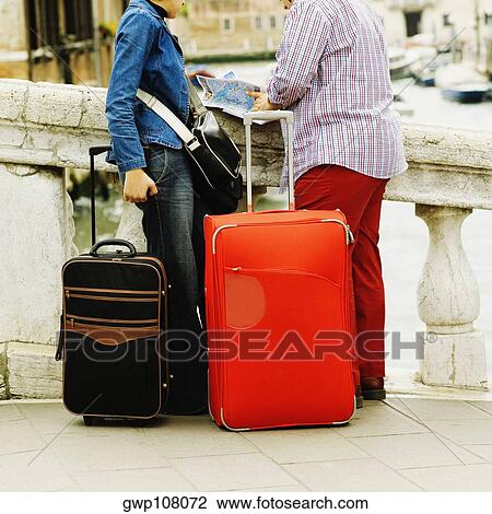 Low section view of a man and a woman looking at a map View Large Photo Image Stock Image - Low section view of a man and a woman looking at a map. Fotosearch