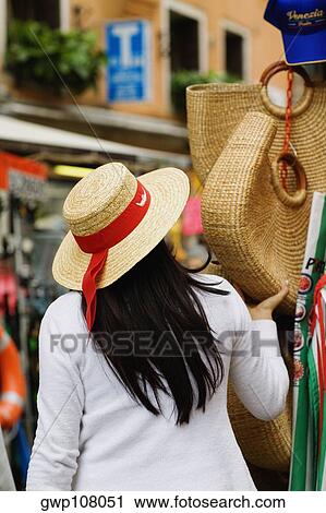 Rear view of a woman at a market stall View Large Photo Image Stock Image - Rear view of a woman at a market stall. Fotosearch