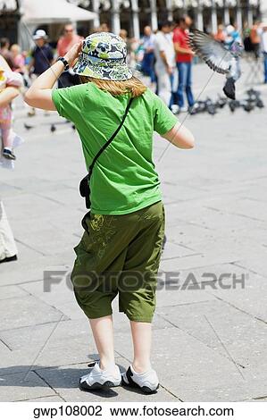 Rear view of a woman standing, Venice, Veneto, Italy View Large Photo Image Stock Image - Rear view of a woman standing, Venice, Veneto, Italy. Fotosearch