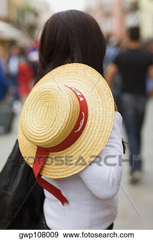 Side profile of a woman holding a hat View Large Photo Image Stock Photo - Side profile of a woman holding a hat. Fotosearch