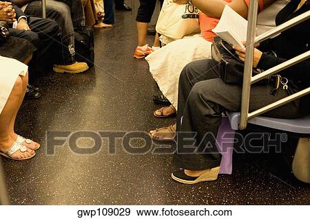 Passengers sitting in a subway train View Large Photo Image Stock Photo - Passengers sitting in a subway train. Fotosearch