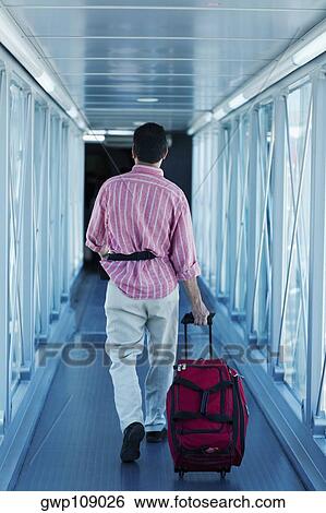 Rear view of a man walking and carrying a bag, Madrid, Spain View Large Photo Image Stock Photograph - Rear view of a man walking and carrying a bag, Madrid, Spain. Fotosearch