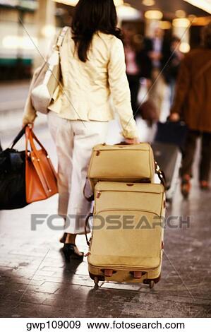 Rear view of a woman walking at a railroad station platform, Rome, Italy View Large Photo Image Stock Photo - Rear view of a woman walking at a railroad station platform, Rome, Italy. Fotosearch
