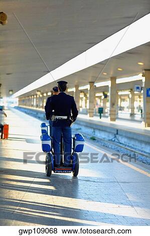 Rear view of two policemen traveling on scooters at a railroad station platform, Rome, Italy View Large Photo Image Stock Photo - Rear view of two policemen traveling on scooters at a railroad station platform, Rome, Italy. Fotosearch