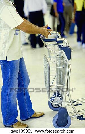 Side profile of a person standing beside a luggage cart, Madrid, Spain View Large Photo Image Stock Photography - Side profile of a person standing beside a luggage cart, Madrid, Spain. Fotosearch