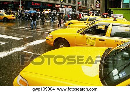 Yellow taxi waiting at the zebra crossing View Large Photo Image Picture - Yellow taxi waiting at the zebra crossing. Fotosearch
