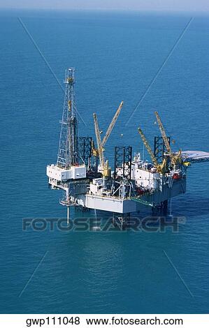 Stock Photo - Aerial view of oil derrick in Mediterranean. Fotosearch