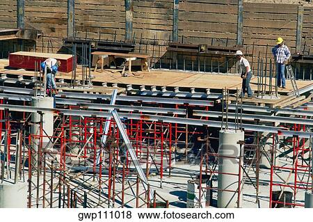Construction workers at building site View Large Photo Image Stock Photo - Construction workers at building site. Fotosearch
