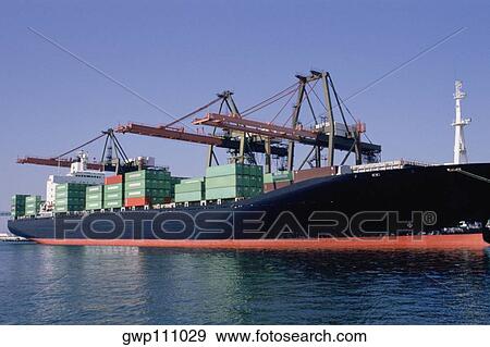 Container ship being loaded at the dock View Large Photo Image Stock Photo - Container ship being loaded at the dock. Fotosearch