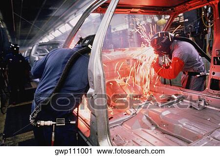 Stock Image - Workers weld car bodies, Chrysler plant, Newark, Delaware. Fotosearch