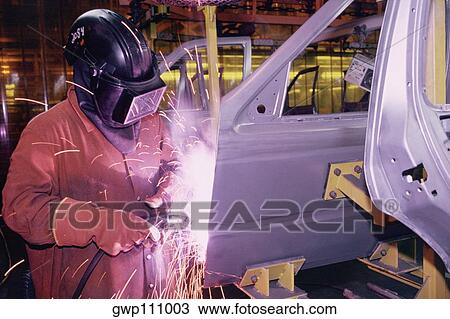 Stock Image - Workers weld car bodies, Chrysler plant, Newark, Delaware. Fotosearch