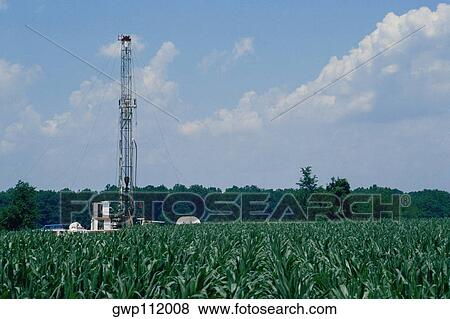 Oil rig in agricultural field View Large Photo Image Stock Photo - Oil rig in agricultural field. Fotosearch