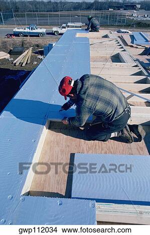 Picture - Putting insulation into solar-powered home, Maryland. Fotosearch