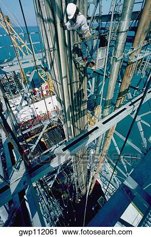Worker on an oil derrick View Large Photo Image Stock Image - Worker on an oil derrick . Fotosearch