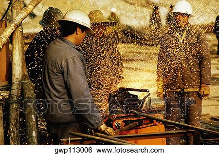 Construction workers working at a construction site, Beijing, China View Large Photo Image Stock Photograph - Construction workers working at a construction site, Beijing, China. Fotosearch