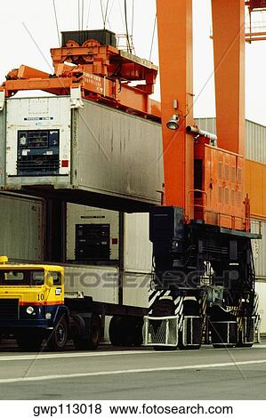 Container being loaded on a ship by a crane, Hong Kong, China View Large Photo Image Stock Photo - Container being loaded on a ship by a crane, Hong Kong, China. Fotosearch
