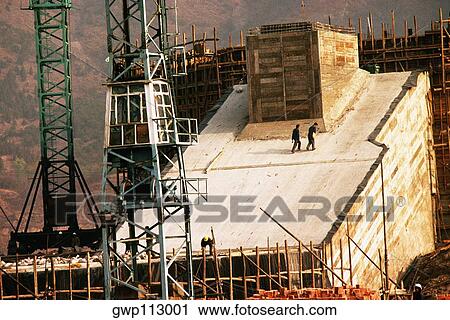 Stock Image - Crane at a under construction dam, China. Fotosearch