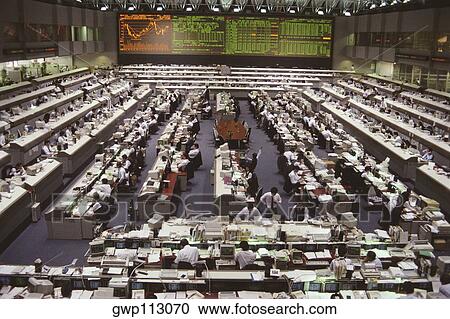 Stock Image - High angle view of a group of people working in a financial company, Tokyo Prefecture, Japan. Fotosearch