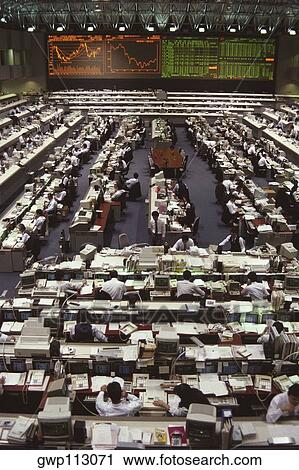 Stock Image - High angle view of a group of people working in a financial company, Tokyo Prefecture, Japan. Fotosearch