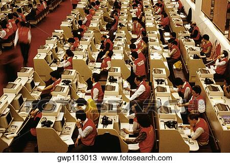 High angle view of businessmen and businesswomen working at a stock exchange, Hong Kong, China View Large Photo Image Stock Image - High angle view of businessmen and businesswomen working at a stock exchange, Hong Kong, China. Fotosearch