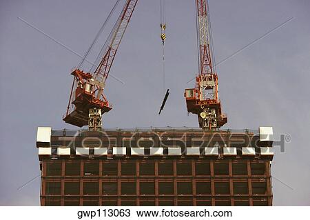 Low angle view of two cranes at a construction site, Tokyo Prefecture, Japan View Large Photo Image Stock Image - Low angle view of two cranes at a construction site, Tokyo Prefecture, Japan. Fotosearch